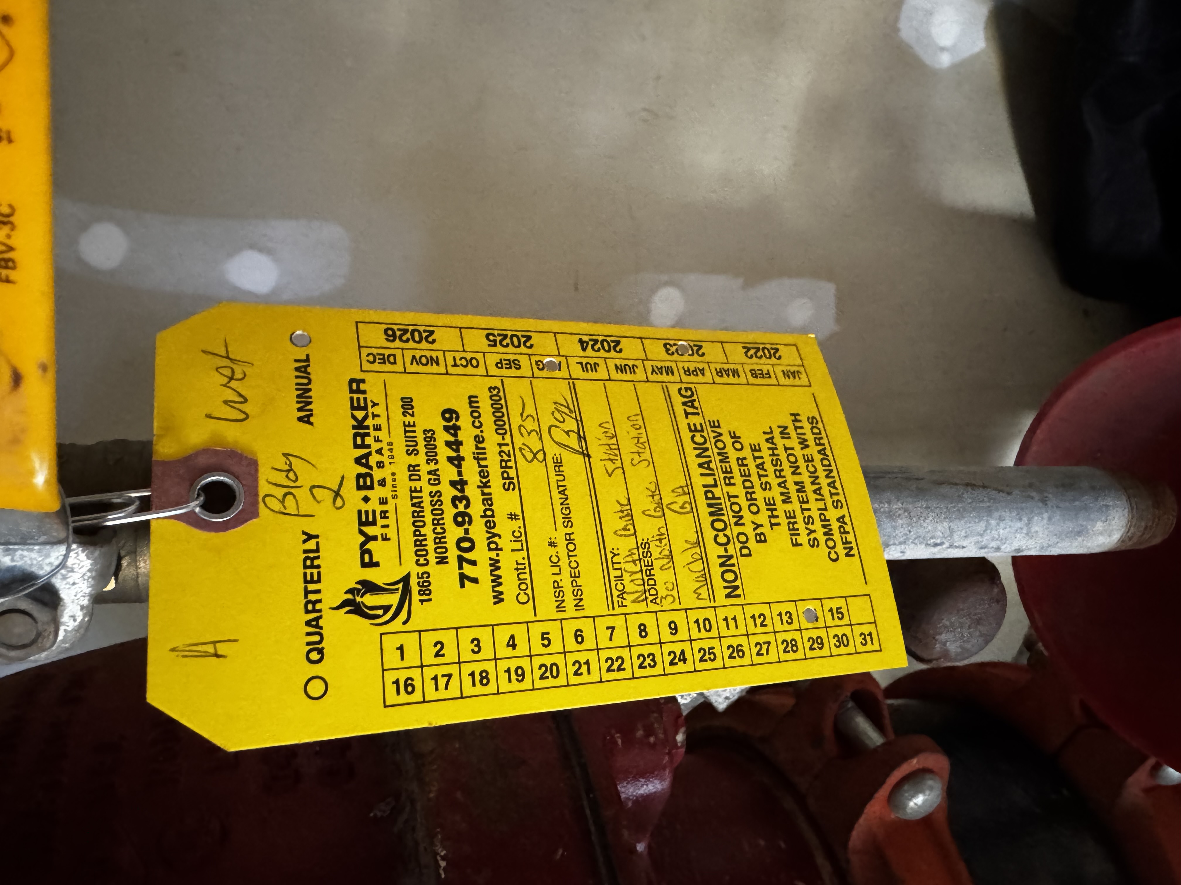 NON-COMPLIANCE tag on sprinkler system riser (second tag), January 16, 2026
